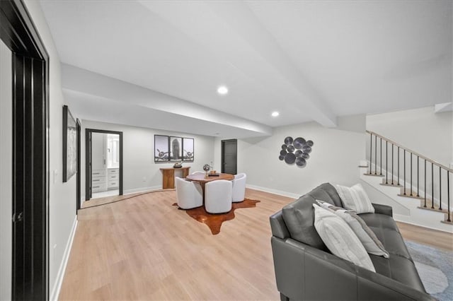 living room with baseboards, light wood-type flooring, stairway, recessed lighting, and beamed ceiling
