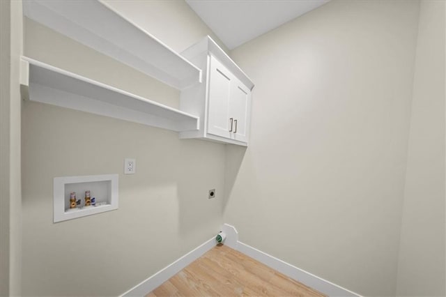 laundry room with hookup for an electric dryer, baseboards, light wood-style flooring, hookup for a washing machine, and cabinet space