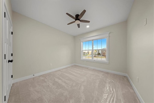 spare room featuring a ceiling fan, light carpet, baseboards, and recessed lighting