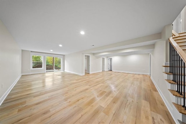 unfurnished living room featuring stairway, light wood-type flooring, baseboards, and recessed lighting