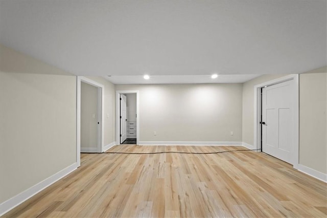 basement with light wood-style floors, baseboards, and recessed lighting