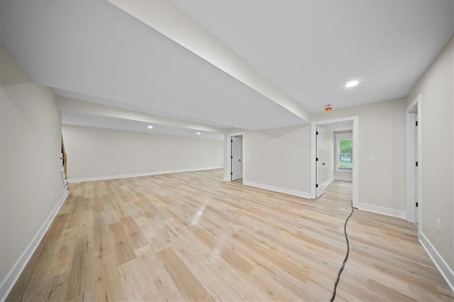 below grade area with light wood-style flooring, recessed lighting, and baseboards
