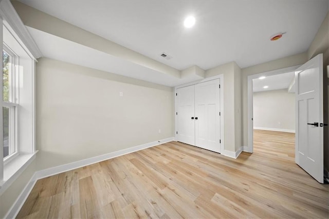 unfurnished bedroom featuring light wood-type flooring, recessed lighting, baseboards, and a closet