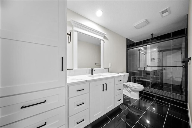 bathroom featuring toilet, a stall shower, vanity, and recessed lighting