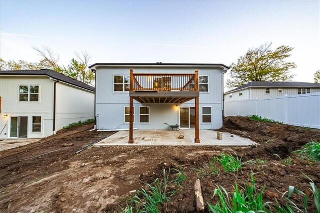 back of property featuring a patio, fence, and a wooden deck