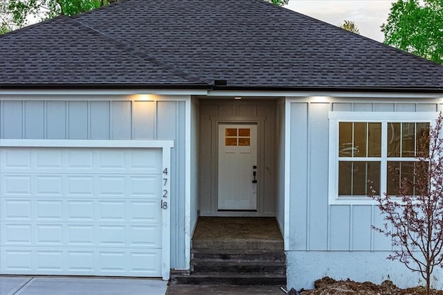 entrance to property featuring a shingled roof and board and batten siding