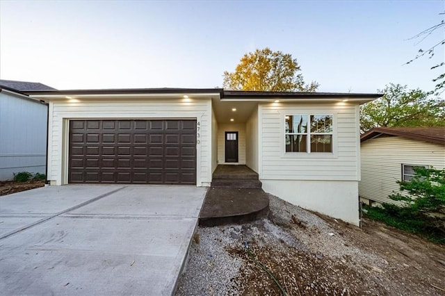 view of front of property with driveway and a garage