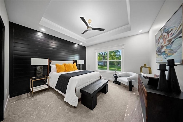 carpeted bedroom with a raised ceiling, baseboards, crown molding, recessed lighting, and a ceiling fan