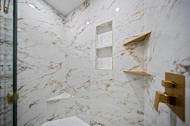 full bath featuring a marble finish shower