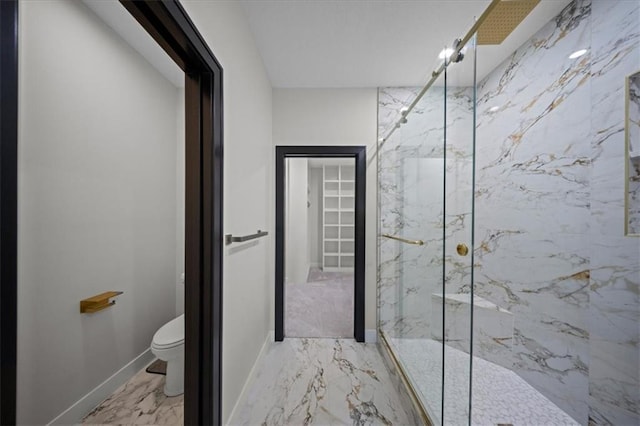 full bath with marble tiled flooring, a marble finish shower, toilet, and baseboards