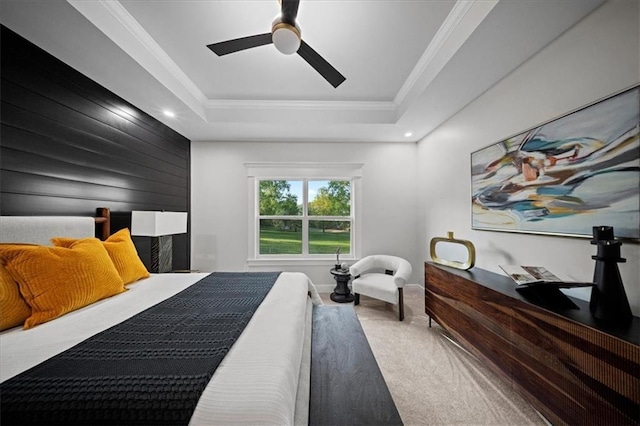 carpeted bedroom featuring a tray ceiling, crown molding, ceiling fan, and recessed lighting