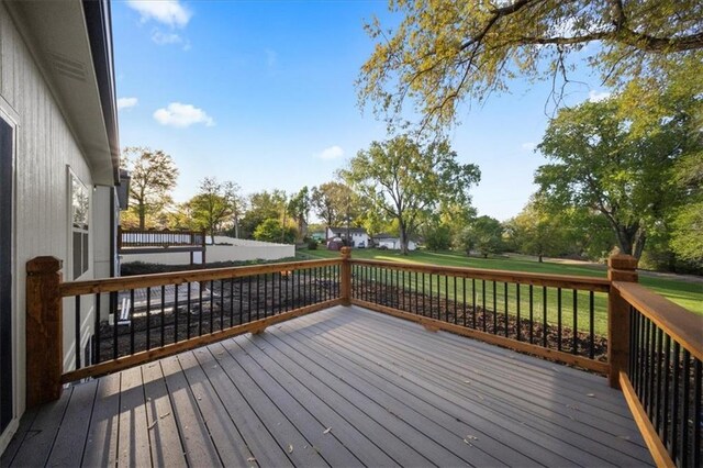 wooden terrace featuring a yard