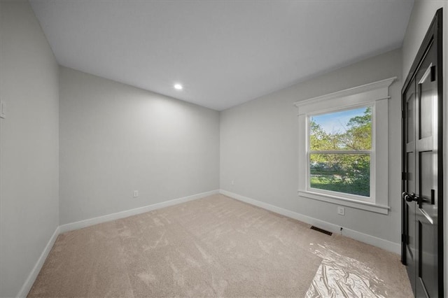 unfurnished room with baseboards, light colored carpet, and recessed lighting