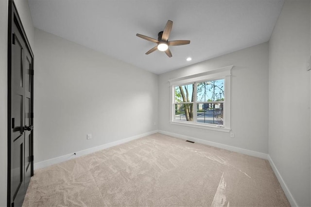 empty room with baseboards, light colored carpet, a ceiling fan, and recessed lighting