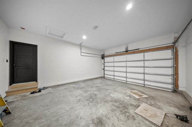 garage featuring recessed lighting and baseboards