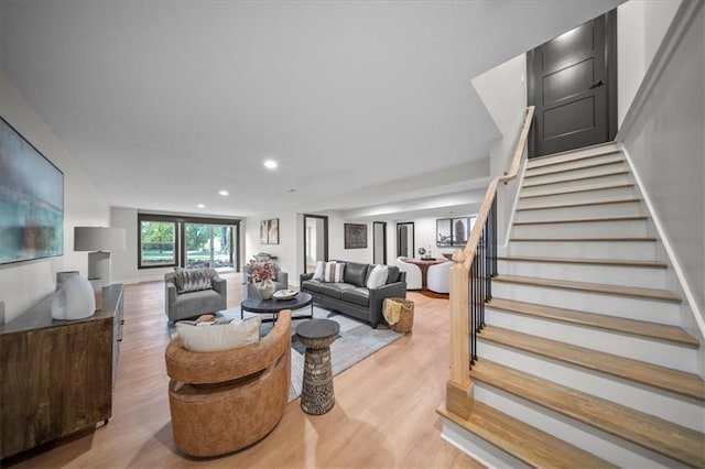 living area featuring stairway, light wood-style floors, and recessed lighting