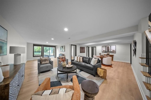 living area with light wood finished floors, baseboards, and recessed lighting