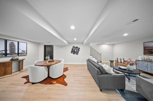 living area featuring light wood finished floors, baseboards, stairway, and recessed lighting