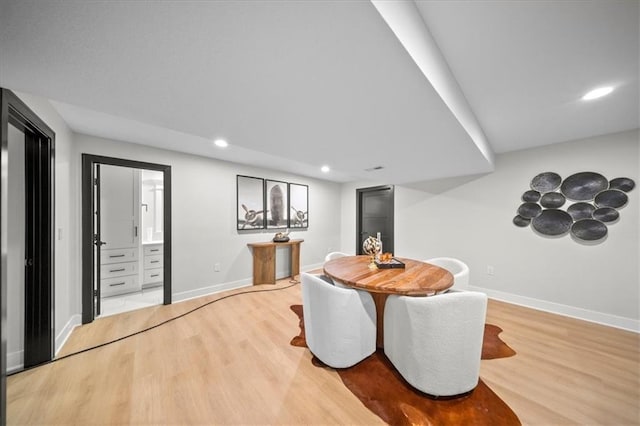 dining space with light wood-style floors, baseboards, and recessed lighting