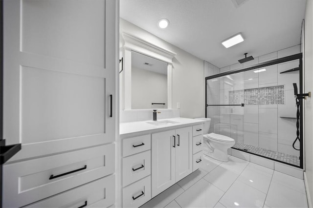 bathroom featuring a stall shower, toilet, and vanity