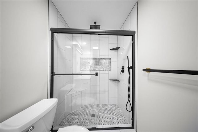 bathroom with toilet and a stall shower