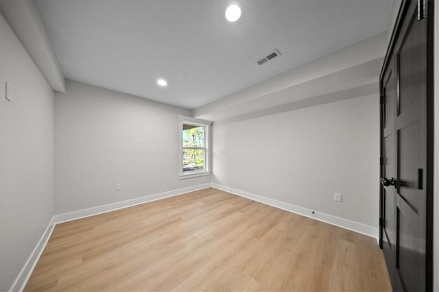 spare room with recessed lighting, light wood-style floors, and baseboards
