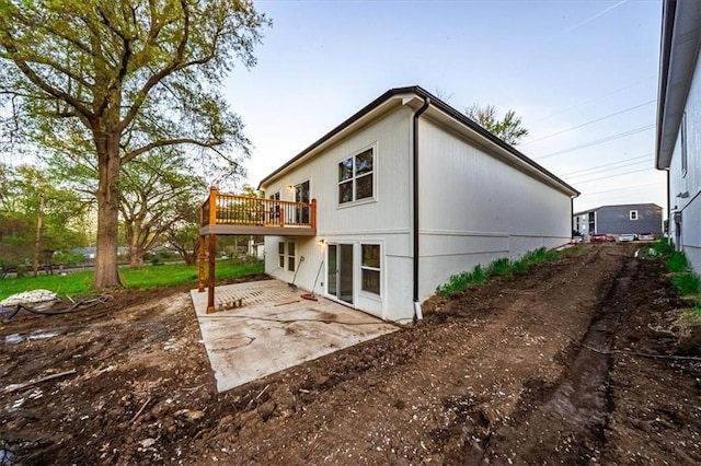 back of property with a patio and a deck