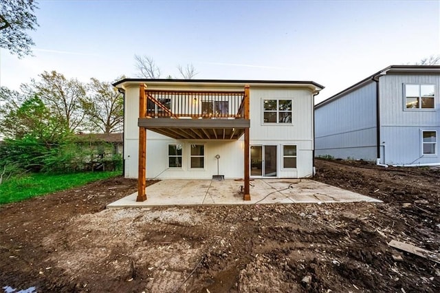 back of house featuring a patio area and a wooden deck