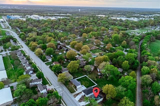 aerial overview of property's location featuring a tree filled landscape