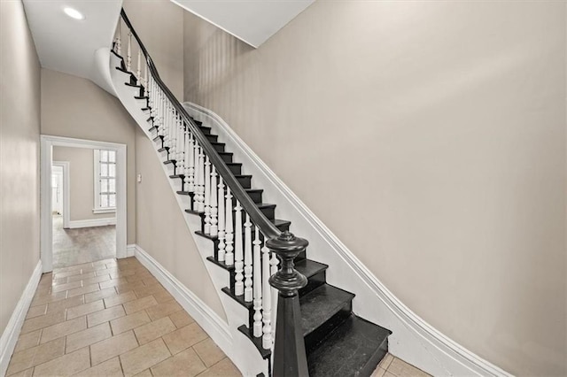staircase featuring baseboards, recessed lighting, and tile patterned flooring