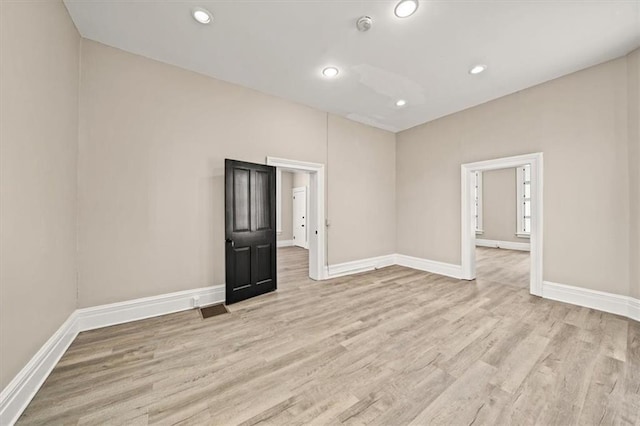 spare room with light wood-type flooring and baseboards