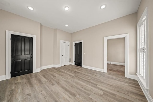 unfurnished bedroom featuring recessed lighting, baseboards, and wood finished floors
