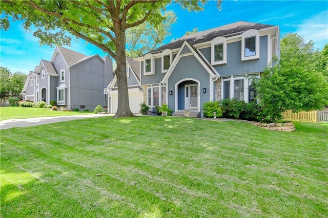 6600 W 125th Ter, Overland Park, KS 66209 - tudor house with stucco siding, driveway, and a garage