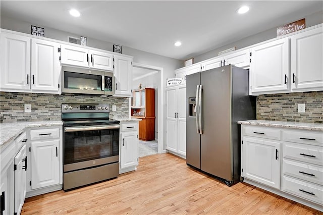 6600 W 125th Ter, Overland Park, KS 66209 - kitchen with stainless steel appliances, white cabinets, light wood-type flooring, and recessed lighting