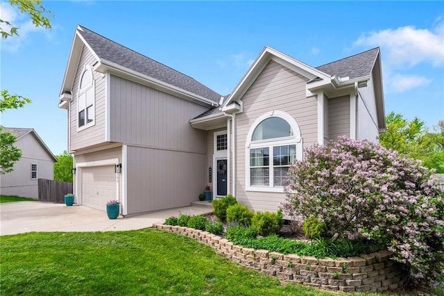 view of front of home with a garage, a front lawn, fence, roof with shingles, and driveway