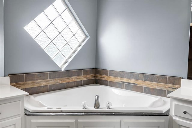 full bath featuring vanity and a bath