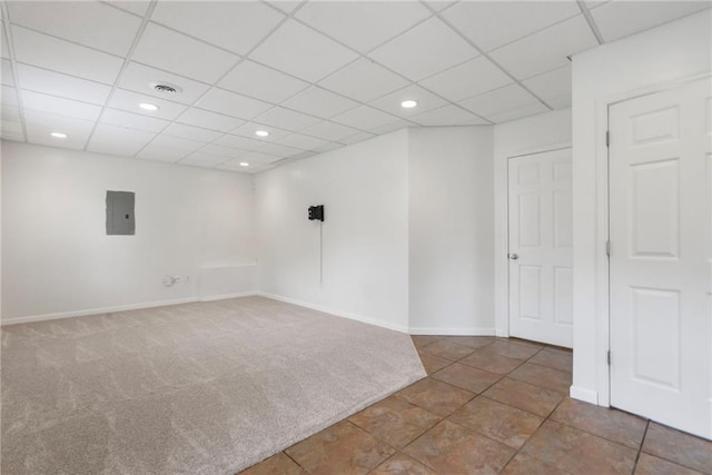 unfurnished room with electric panel, a paneled ceiling, carpet floors, baseboards, and recessed lighting