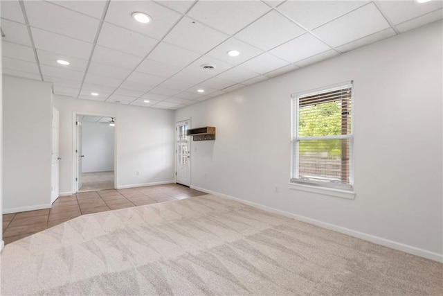 tiled spare room featuring baseboards, recessed lighting, carpet, and a drop ceiling