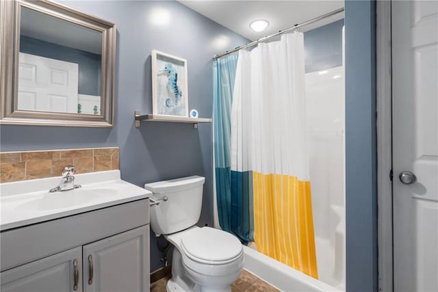 bathroom with vanity, a shower with shower curtain, and toilet