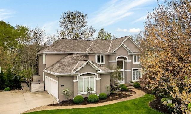 10863 S Cedar Niles Cir, Olathe, KS 66061 - traditional home featuring stucco siding, driveway, and a garage