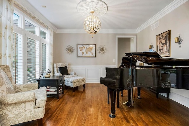 10863 S Cedar Niles Cir, Olathe, KS 66061 - living area featuring wood finished floors, a chandelier, crown molding, and a wainscoted wall