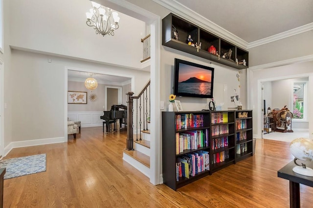 10863 S Cedar Niles Cir, Olathe, KS 66061 - hallway featuring a chandelier, stairway, wood finished floors, ornamental molding, and a wainscoted wall