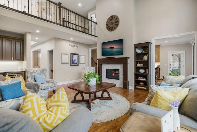 10863 S Cedar Niles Cir, Olathe, KS 66061 - living room with a high ceiling, wood finished floors, a fireplace, baseboards, and recessed lighting