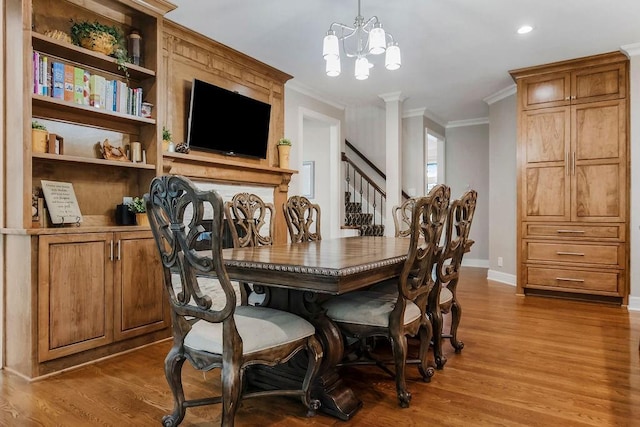 10863 S Cedar Niles Cir, Olathe, KS 66061 - dining space featuring wood finished floors, crown molding, baseboards, a chandelier, and stairway