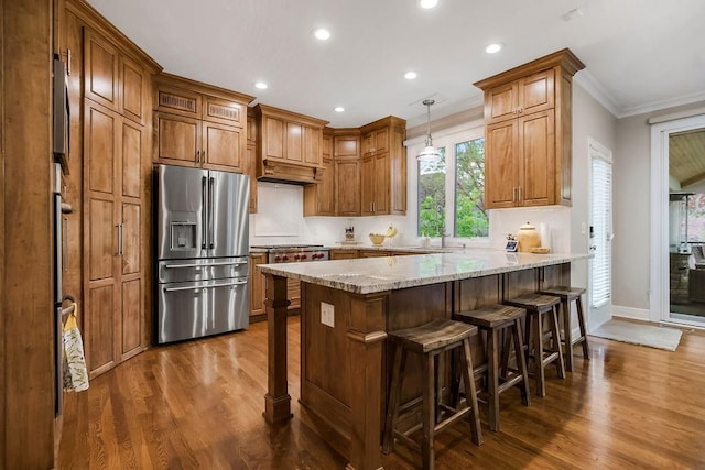 10863 S Cedar Niles Cir, Olathe, KS 66061 - kitchen featuring stainless steel fridge with ice dispenser, a peninsula, dark wood-type flooring, ornamental molding, and light stone counters