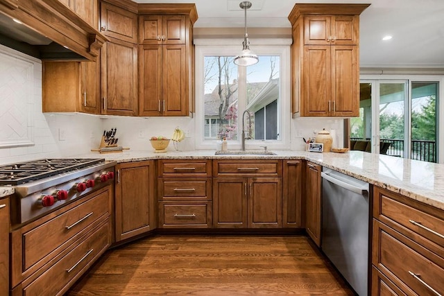 10863 S Cedar Niles Cir, Olathe, KS 66061 - kitchen with appliances with stainless steel finishes, a sink, brown cabinets, dark wood-style floors, and crown molding
