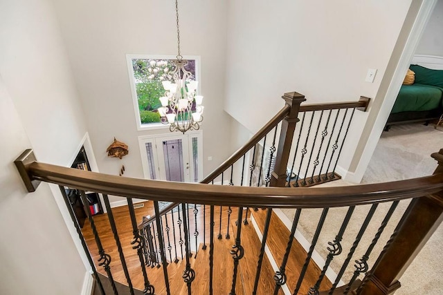 10863 S Cedar Niles Cir, Olathe, KS 66061 - stairway with a towering ceiling, a chandelier, baseboards, and carpet floors