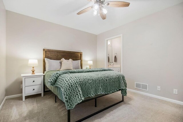 10863 S Cedar Niles Cir, Olathe, KS 66061 - bedroom with carpet, baseboards, a ceiling fan, and connected bathroom