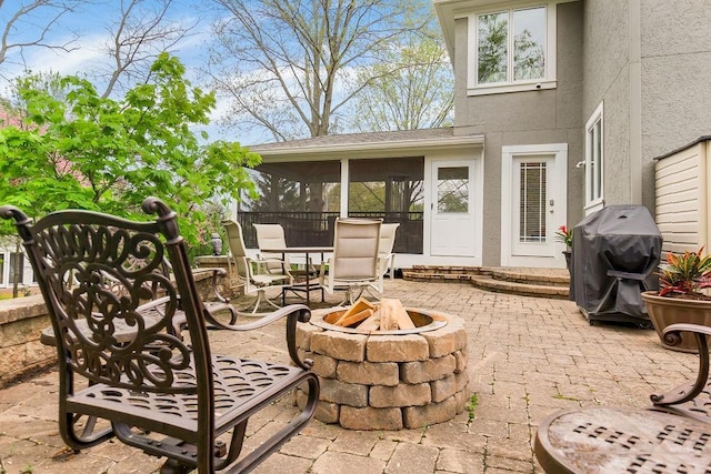 10863 S Cedar Niles Cir, Olathe, KS 66061 - view of patio / terrace with an outdoor fire pit, grilling area, and a sunroom