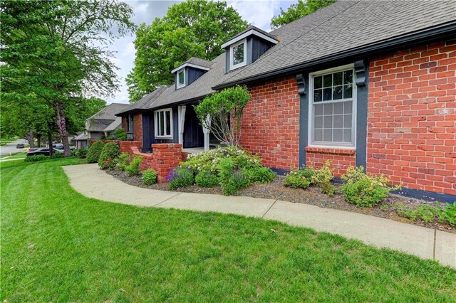 1400 SW 8th Ter, Lees Summit, MO 64081 - view of side of home with a yard, brick siding, and a shingled roof